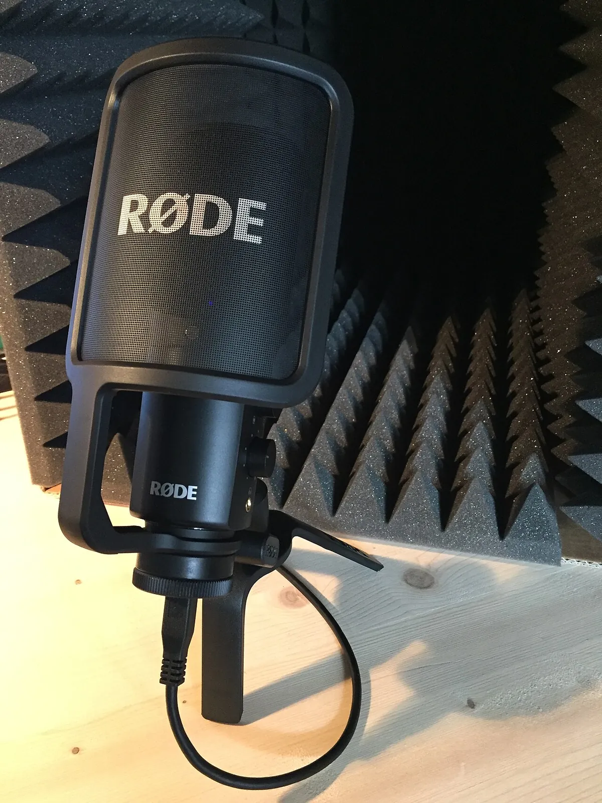 Black USB condenser microphone on a desk stand