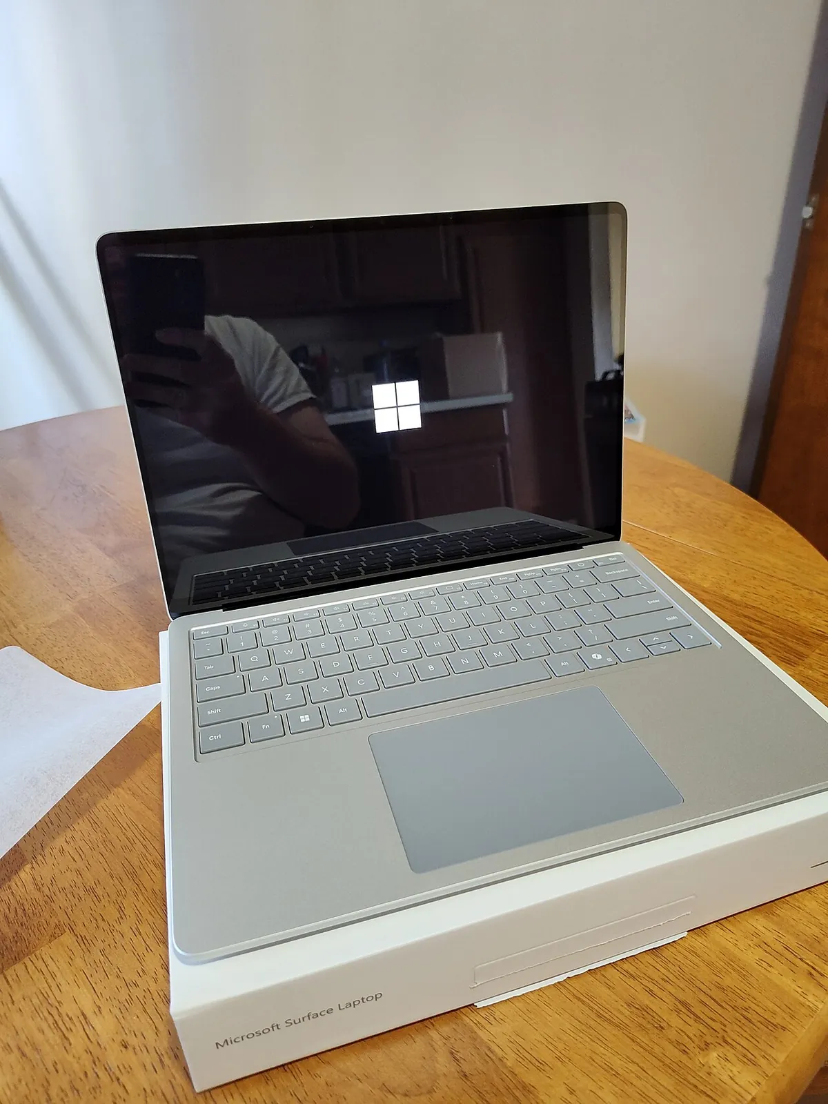 Windows 11 laptop open on a wooden desk